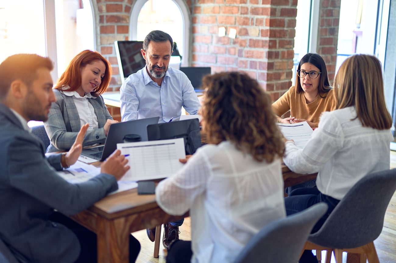 Group of employees meeting and planning out project tasks